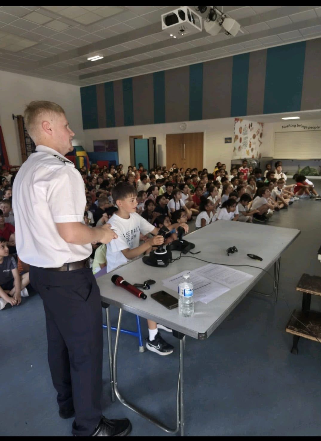 Pilot speaking to pupils at an aviation assembly