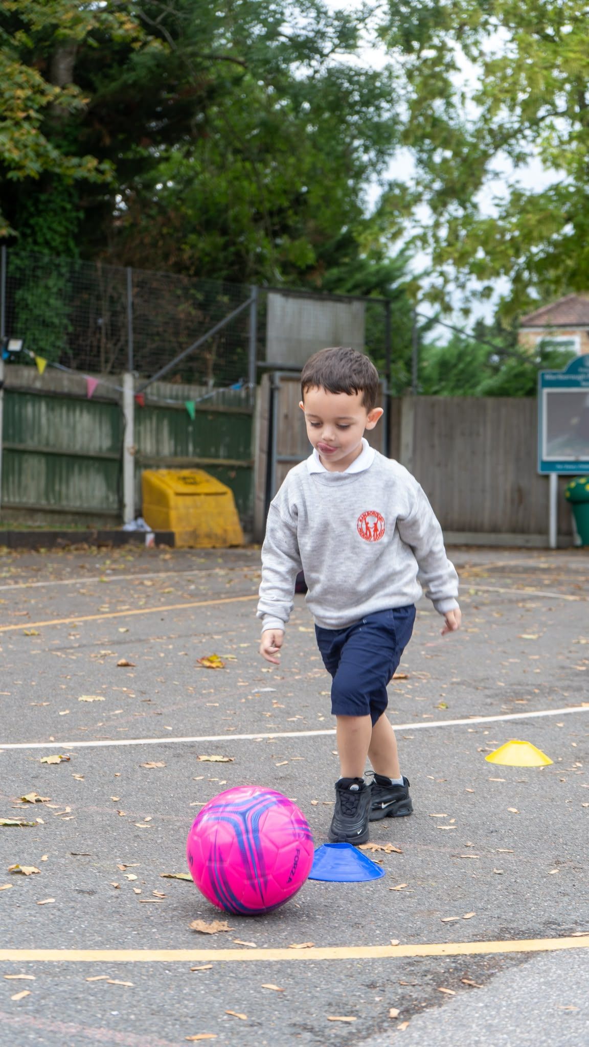 Child dribbling a football at club