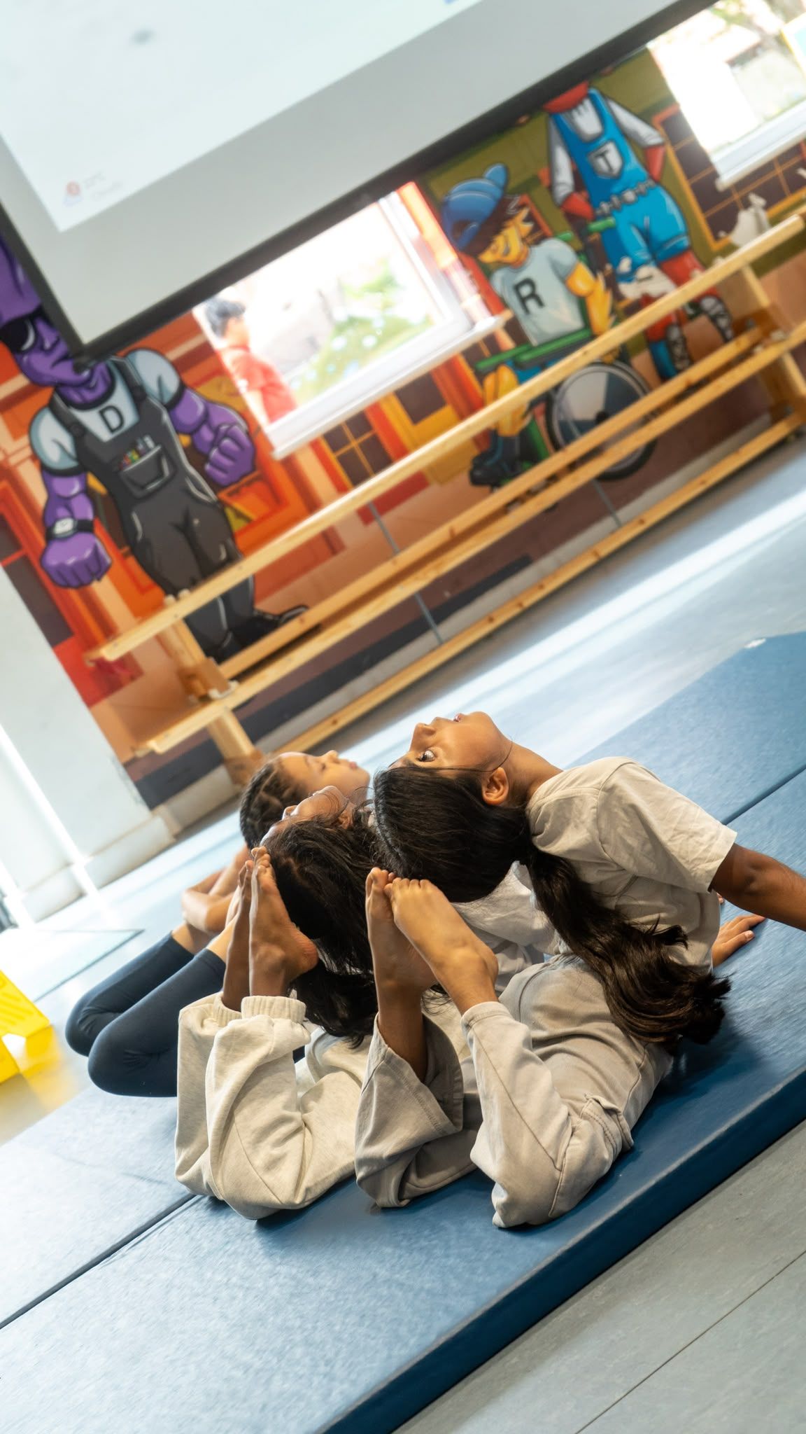 Children enjoying mat stretch at Active Minds