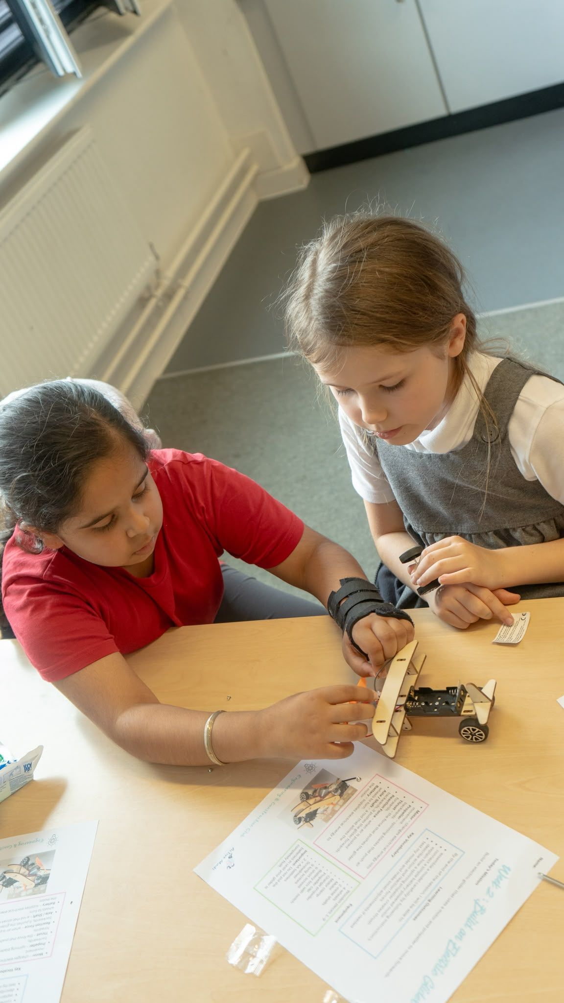 Children enjoying stem wooden car at Active Minds
