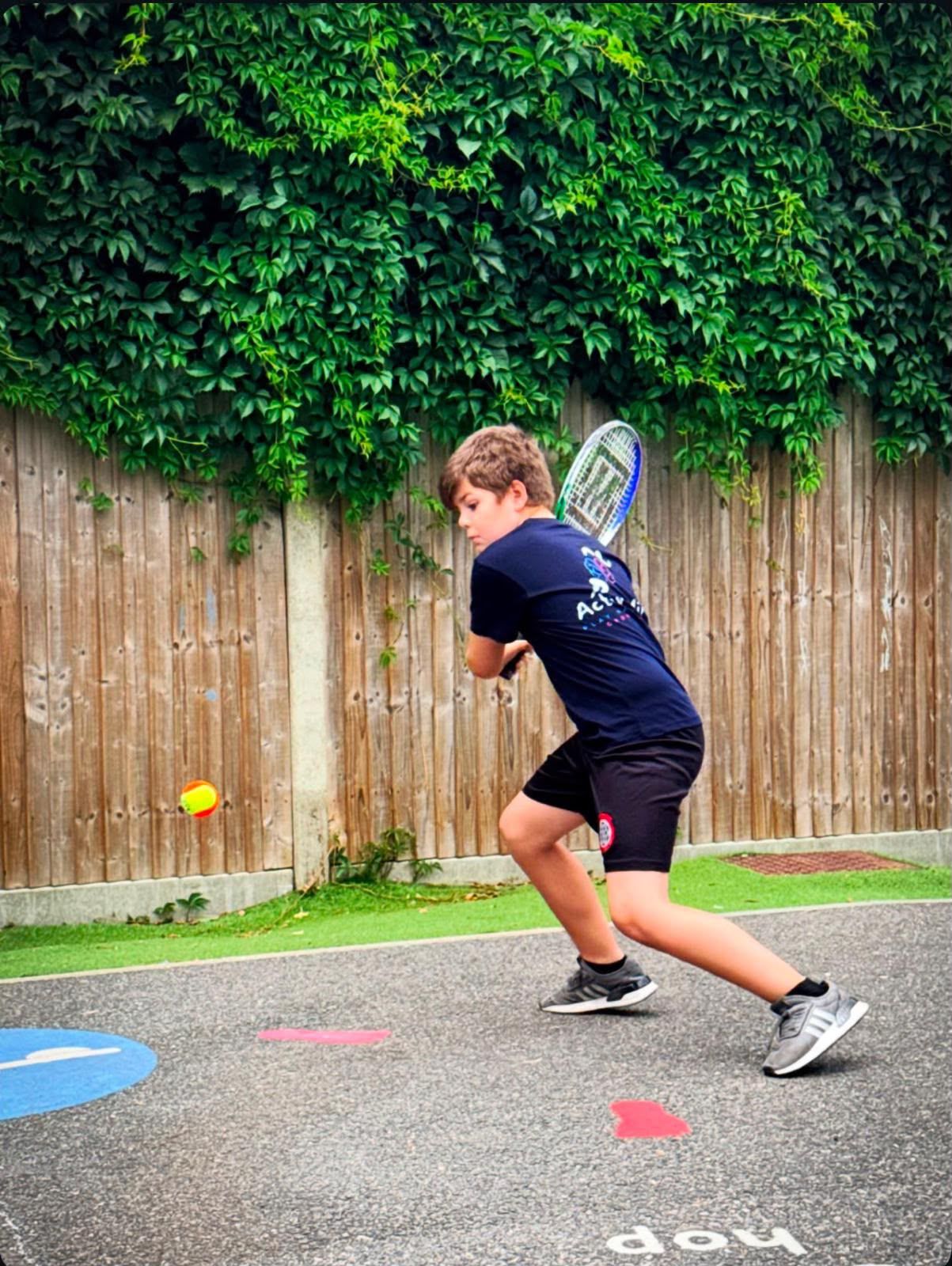 Boy playing a tennis backhand